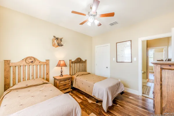 a bedroom with 2 bed and a chandelier