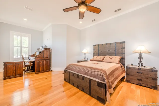 a spacious bedroom with a bed and a chandelier