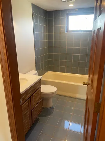 a bathroom with a sink mirror toilet and bathtub