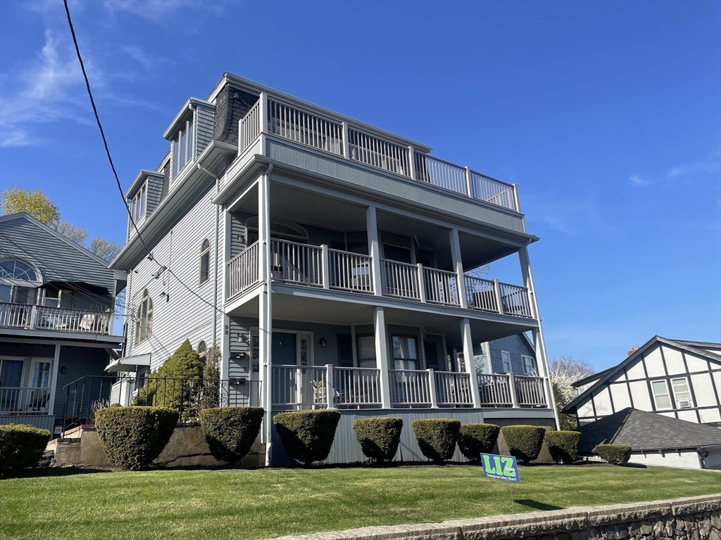 98 Rockland Street, Unit 3 Swampscott, MA 01907 - Photo 18 of 19 a front view of a house with a garden