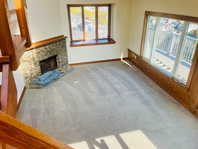 a view of an empty room with a fireplace