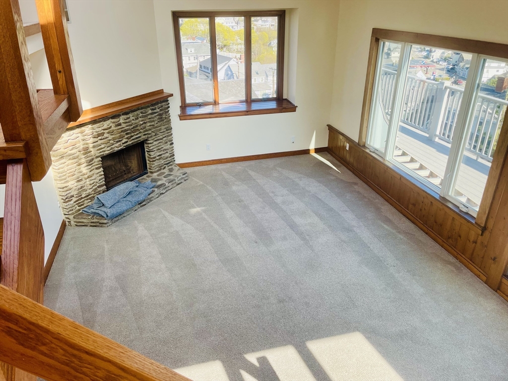 98 Rockland Street, Unit 3 Swampscott, MA 01907 - Photo 2 of 16 a view of an empty room with a fireplace