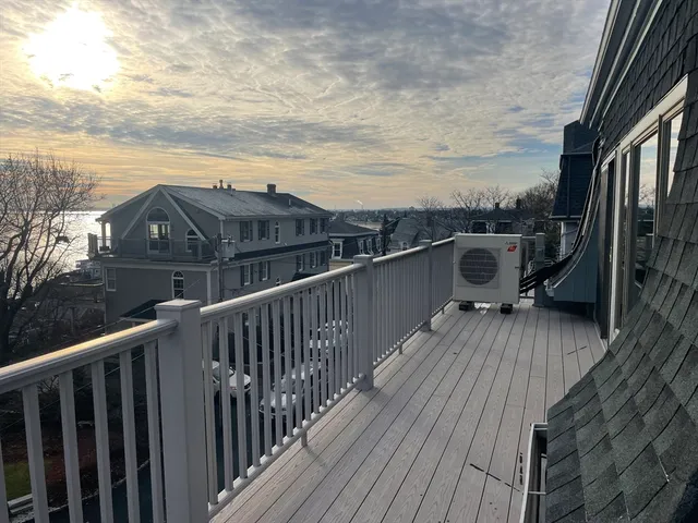 a view of balcony with wooden floor and fence