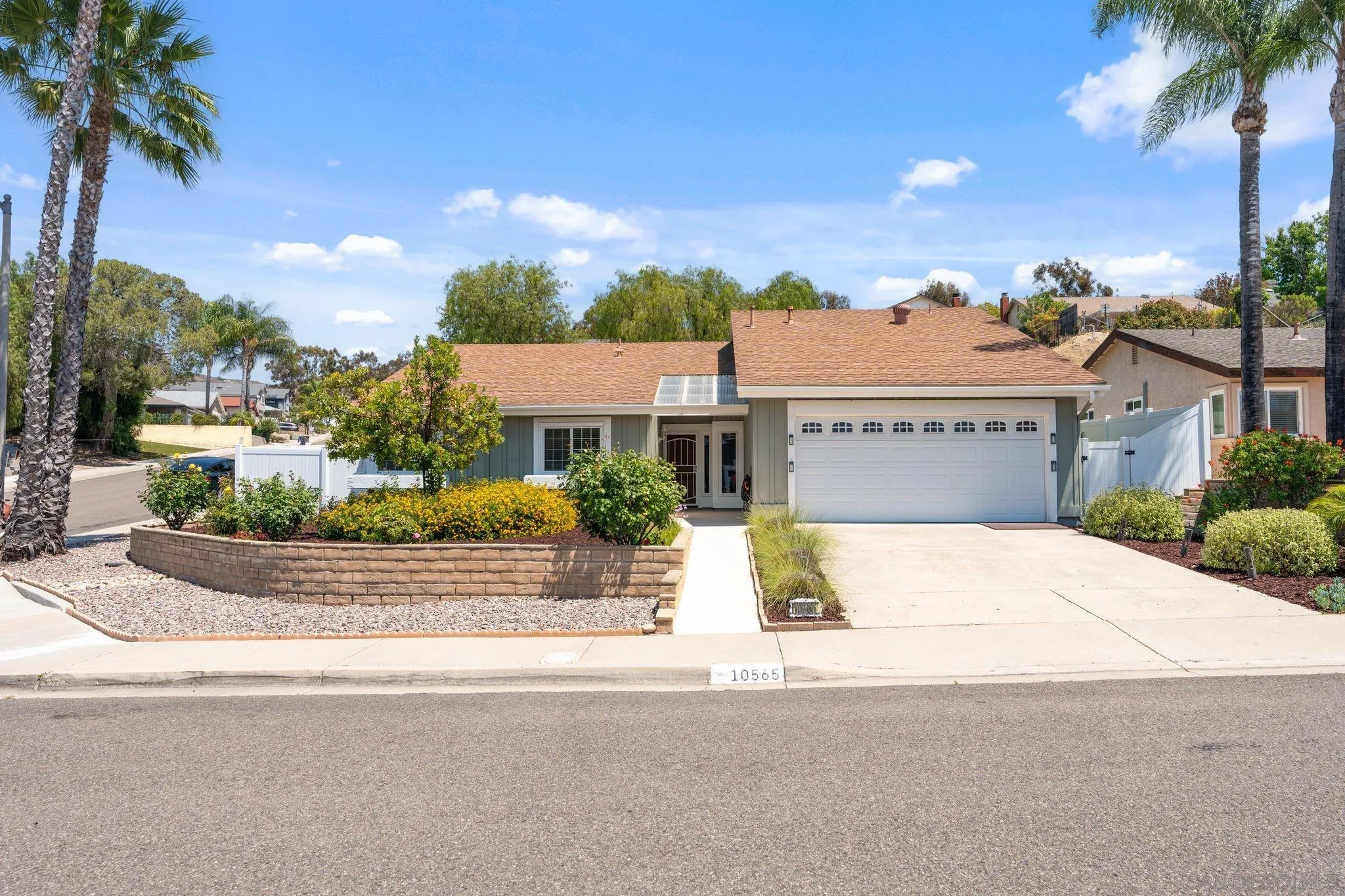 10565 Strathmore Drive Santee, CA 92071 - Photo 52 of 59 front view of house with a yard and palm trees