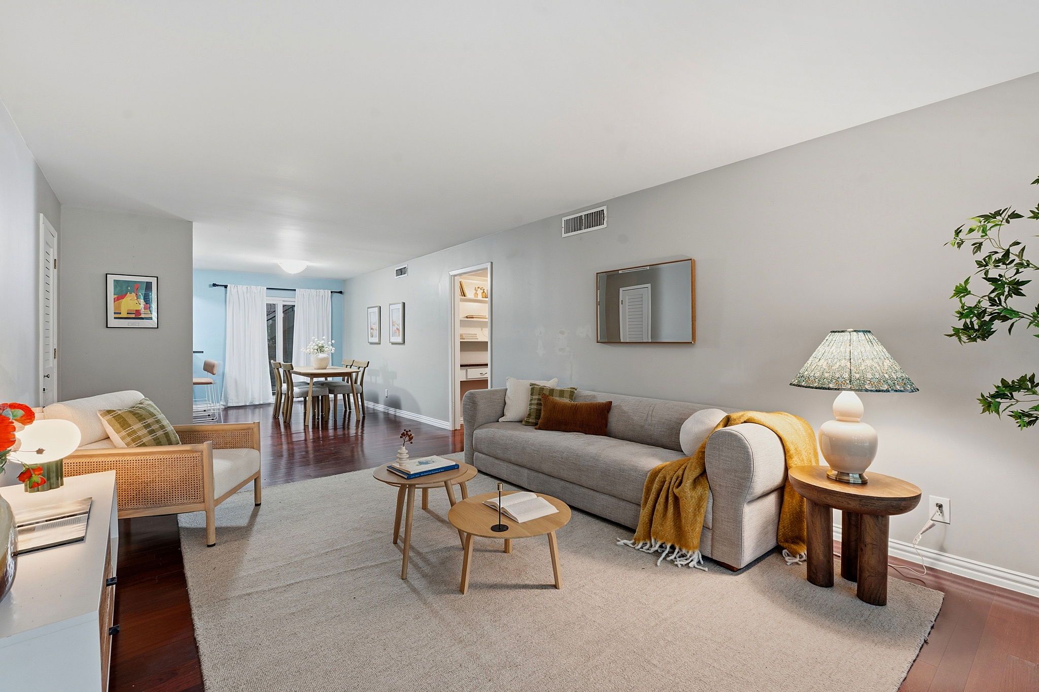 1210 Windsor Road, Unit 104 Austin, TX 78703 - Photo 9 of 29 Rich hardwood floors complement this open-concept living space, ideal for entertaining and daily relaxation.