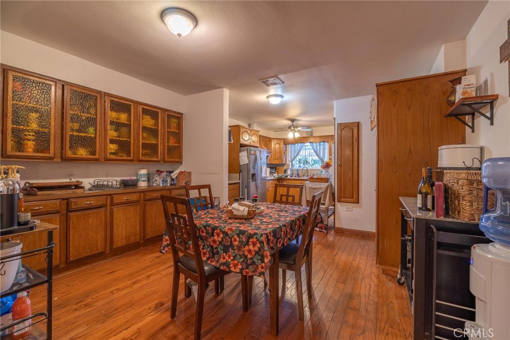 9920 Broadway Temple City, CA 91780 - Photo 7 of 26 a kitchen with stainless steel appliances granite countertop a stove top oven a dining table and chairs with wooden floor