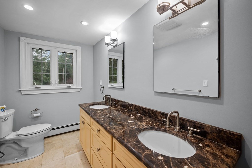 42 Bypass Road Lincoln, MA 01773 - Photo 28 of 42 a bathroom with a granite countertop sink a toilet and a mirror