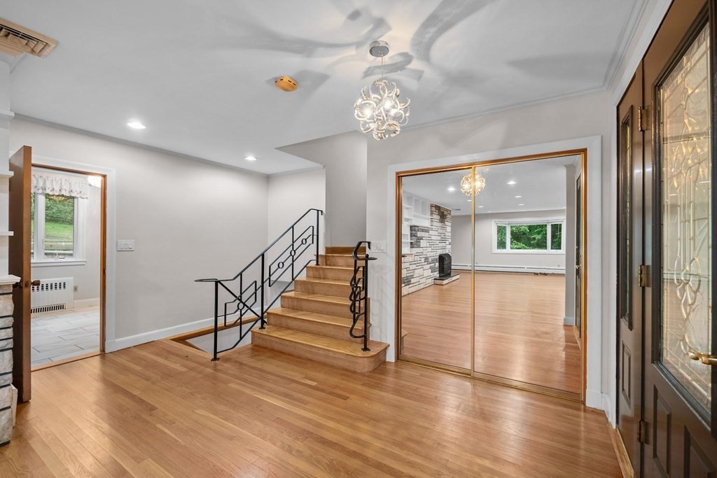 42 Bypass Road Lincoln, MA 01773 - Photo 3 of 42 a view of an entryway with wooden floor and a chandelier