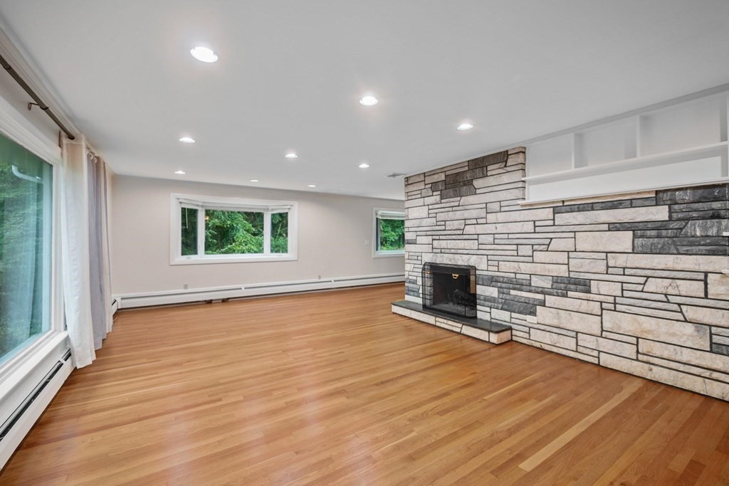 42 Bypass Road Lincoln, MA 01773 - Photo 6 of 42 an empty room with wooden floor and fireplace