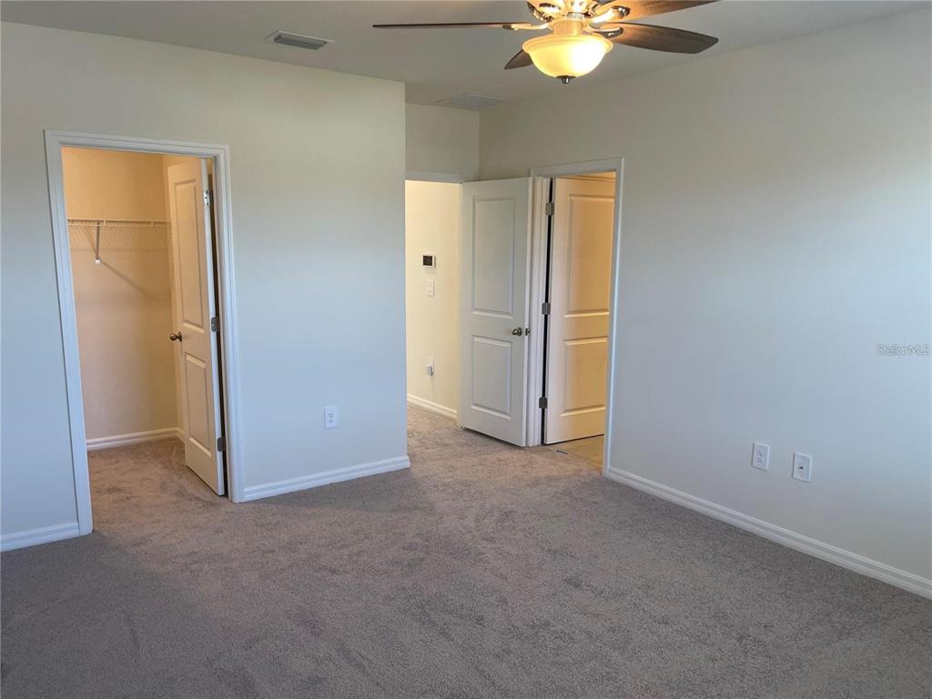 9011 Milestone Drive Sarasota, FL 34238 - Photo 13 of 32 an empty room with closet and a chandelier fan