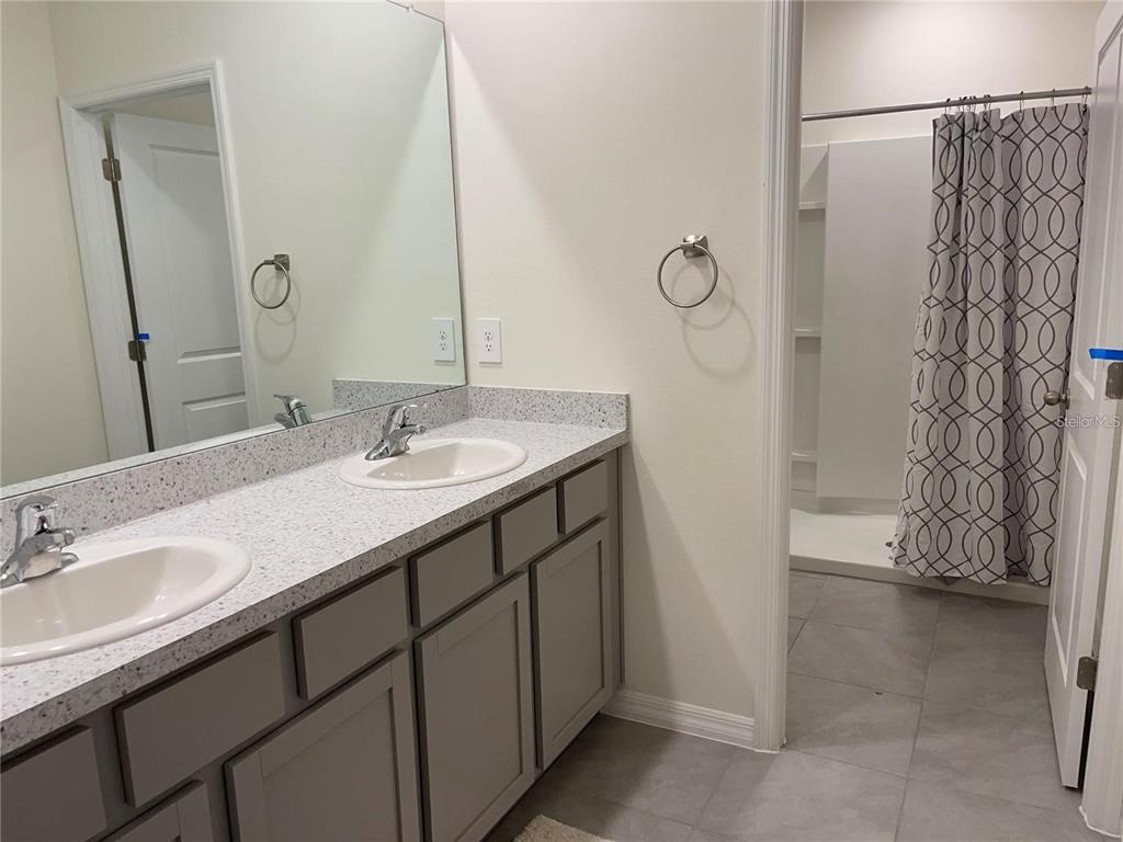 9011 Milestone Drive Sarasota, FL 34238 - Photo 15 of 32 a bathroom with a sink double vanity and a mirror