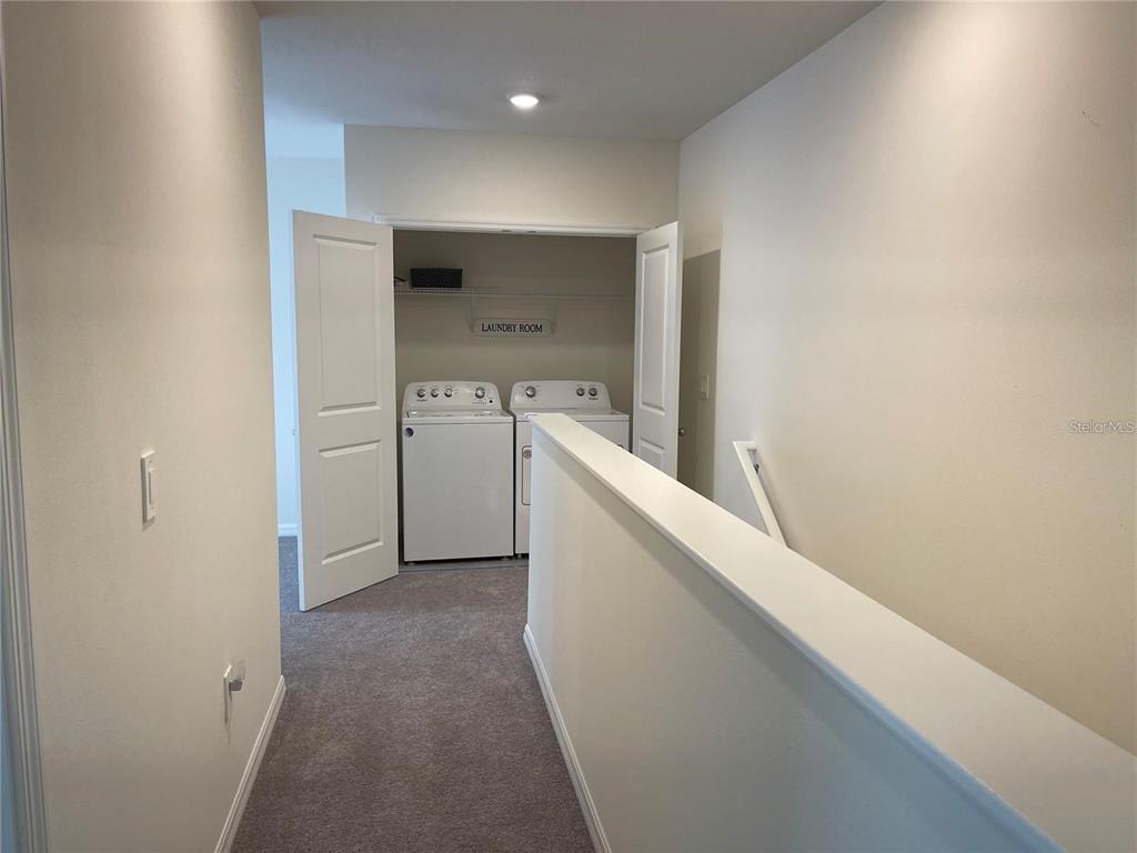 9011 Milestone Drive Sarasota, FL 34238 - Photo 24 of 32 a view of storage and utility room with washer and dryer