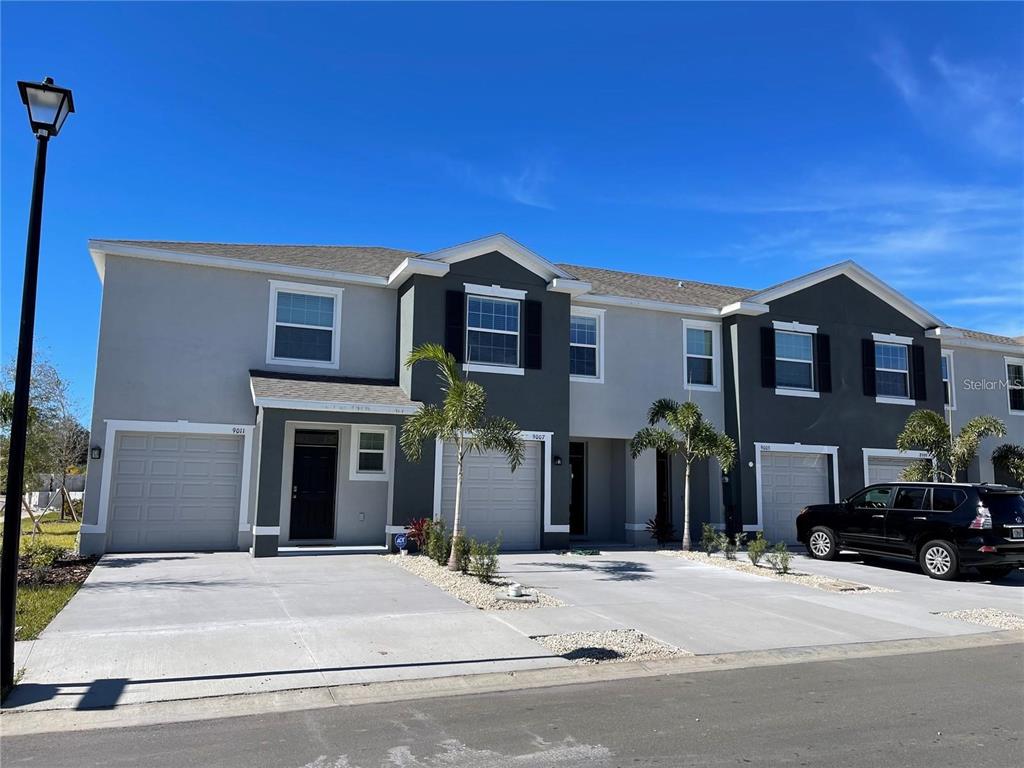 9011 Milestone Drive Sarasota, FL 34238 - Photo 25 of 32 a front view of a house with a yard