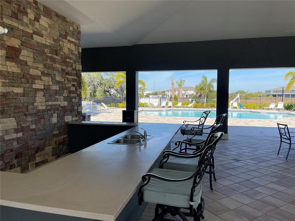 9011 Milestone Drive Sarasota, FL 34238 - Photo 28 of 32 a view of a swimming pool with chair and table