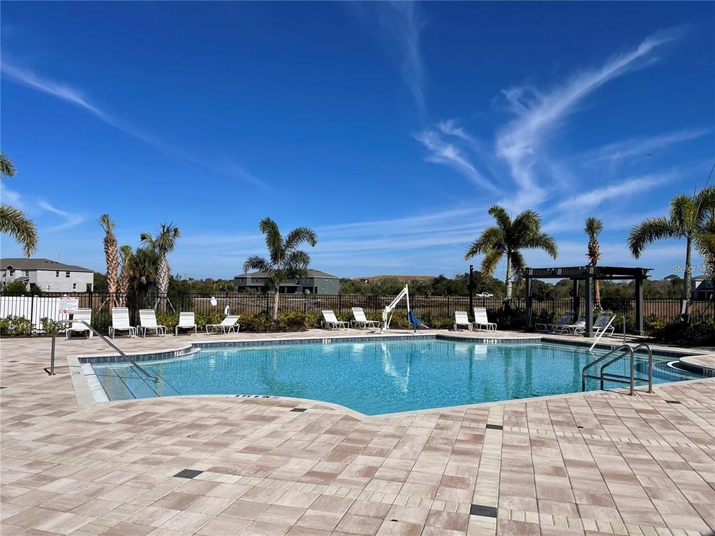 9011 Milestone Drive Sarasota, FL 34238 - Photo 30 of 32 a view of a swimming pool with a lounge chair