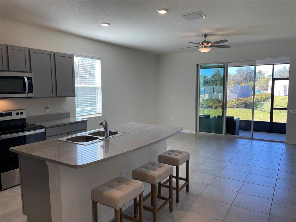 9011 Milestone Drive Sarasota, FL 34238 - Photo 10 of 32 a kitchen with a sink counter top space appliances and cabinets