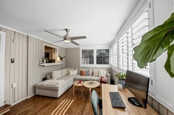 a living room with furniture a rug and a window