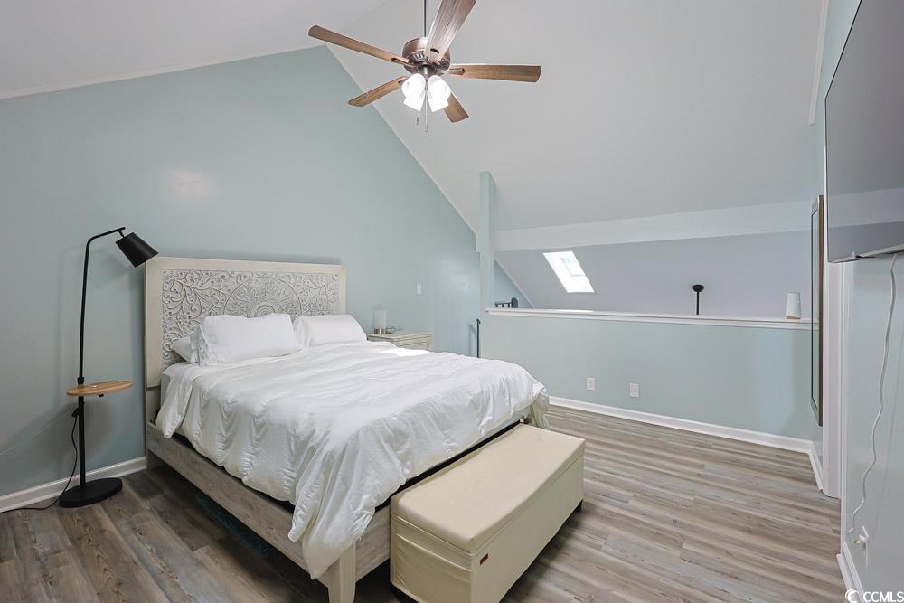 3700 Golf Colony Lane, Unit 5B Little River, SC 29566 - Photo 12 of 27 Bedroom with a skylight, vaulted ceiling, light wood-style flooring, and a ceiling fan