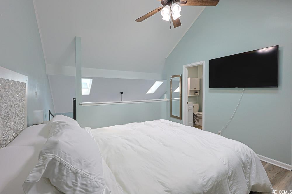 3700 Golf Colony Lane, Unit 5B Little River, SC 29566 - Photo 13 of 27 Bedroom with wood finished floors, a skylight, a ceiling fan, high vaulted ceiling, and ensuite bathroom