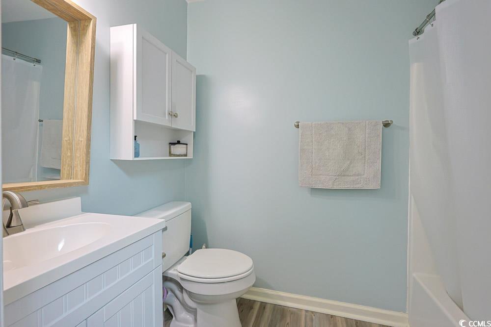 3700 Golf Colony Lane, Unit 5B Little River, SC 29566 - Photo 14 of 27 Bathroom featuring vanity, light wood finished floors, and shower / bathtub combination with curtain