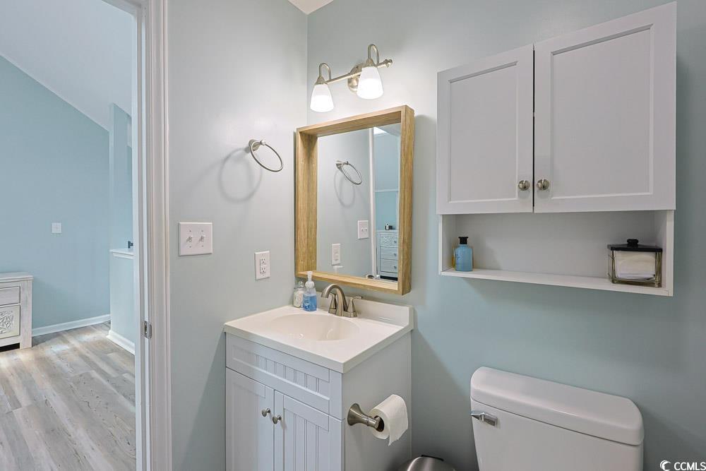 3700 Golf Colony Lane, Unit 5B Little River, SC 29566 - Photo 15 of 27 Bathroom featuring vanity and light wood-type flooring