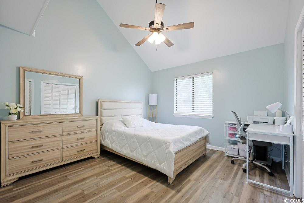 3700 Golf Colony Lane, Unit 5B Little River, SC 29566 - Photo 16 of 27 Bedroom featuring light wood-type flooring, high vaulted ceiling, ceiling fan, and an office area