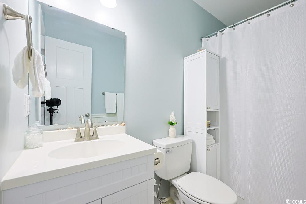 3700 Golf Colony Lane, Unit 5B Little River, SC 29566 - Photo 19 of 27 Full bath featuring vanity and a shower with curtain
