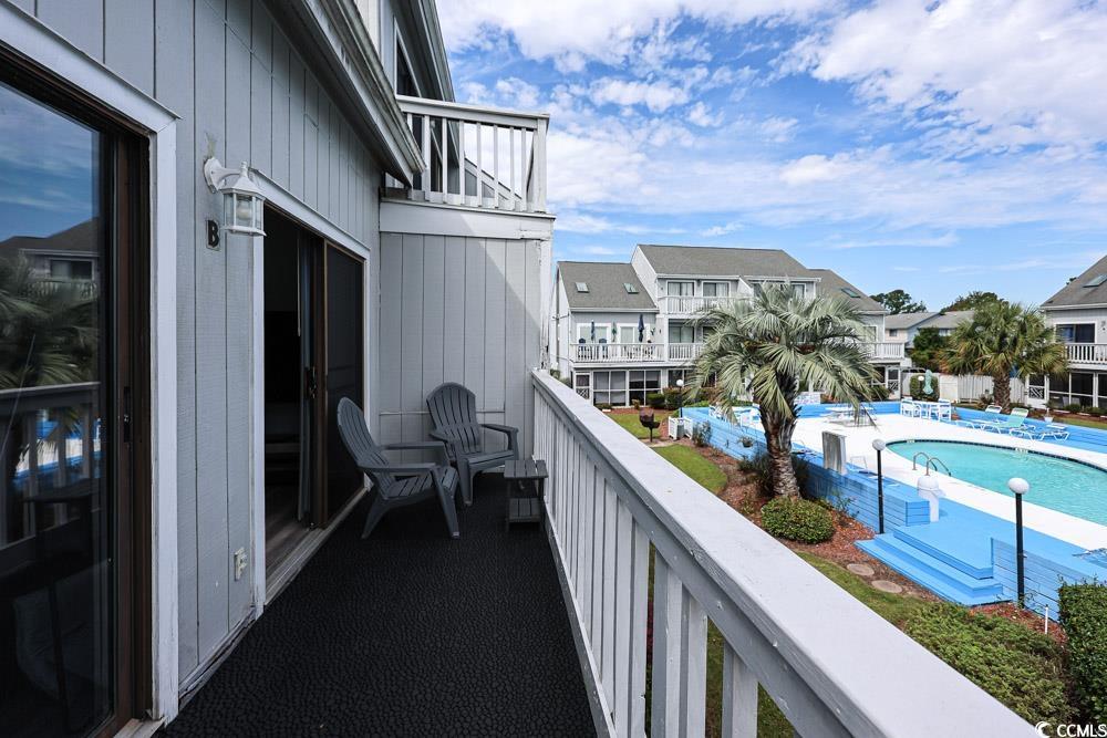 3700 Golf Colony Lane, Unit 5B Little River, SC 29566 - Photo 2 of 27 Balcony featuring view of pool and a residential view