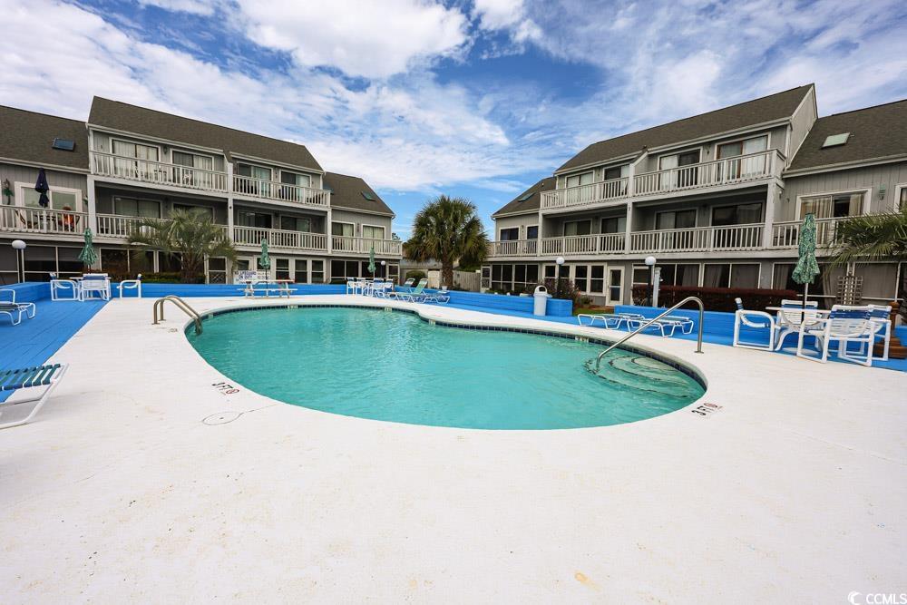 3700 Golf Colony Lane, Unit 5B Little River, SC 29566 - Photo 21 of 27 Community pool featuring a patio area
