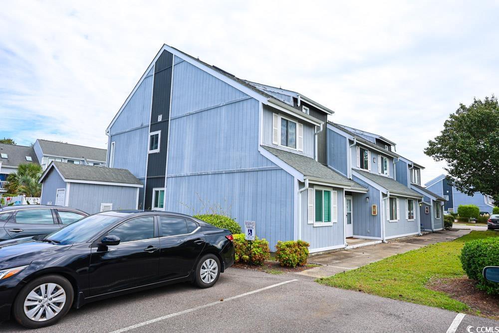 3700 Golf Colony Lane, Unit 5B Little River, SC 29566 - Photo 23 of 27 View of front facade featuring uncovered parking, a residential view, and roof with shingles