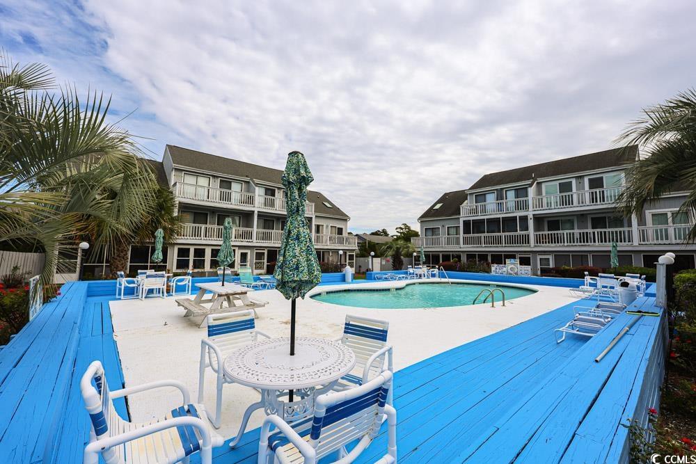3700 Golf Colony Lane, Unit 5B Little River, SC 29566 - Photo 24 of 27 Community pool featuring a patio area and a deck