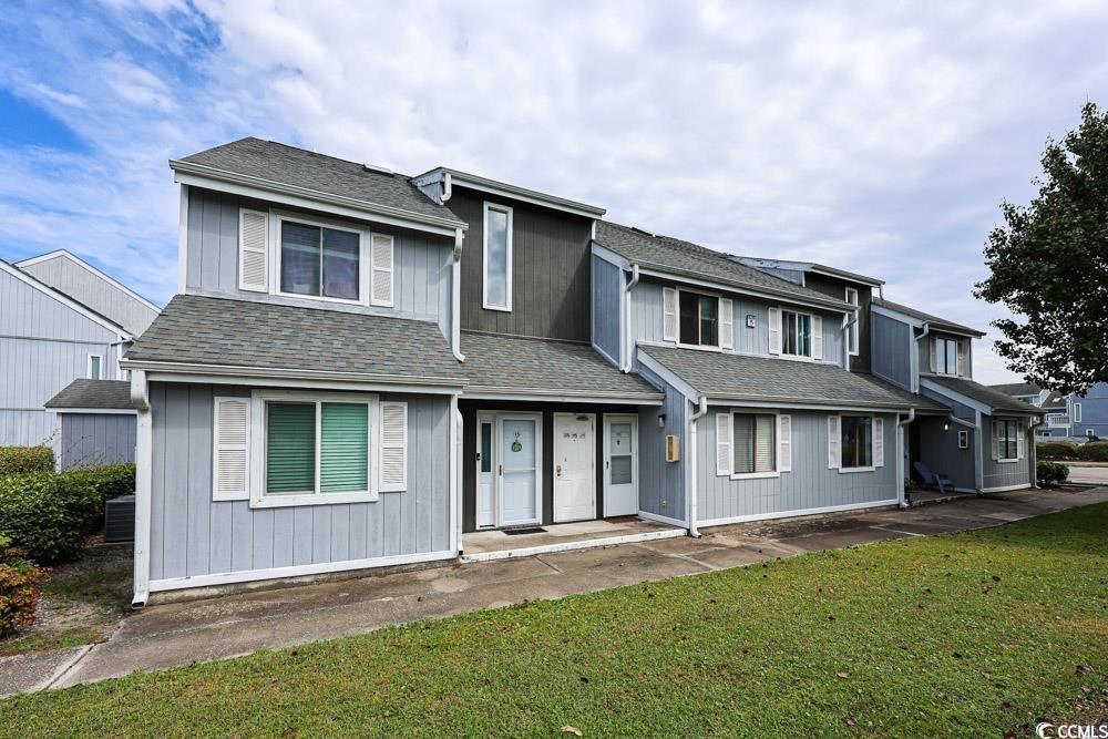 3700 Golf Colony Lane, Unit 5B Little River, SC 29566 - Photo 26 of 27 Traditional-style house with roof with shingles and a front lawn
