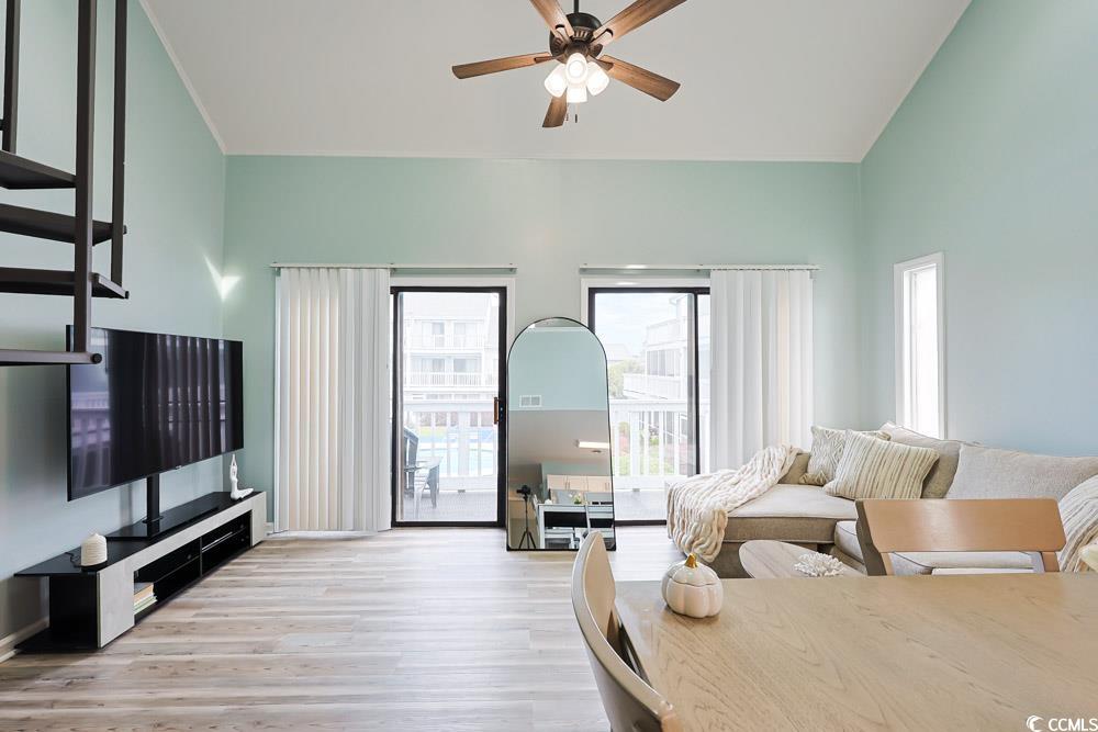 3700 Golf Colony Lane, Unit 5B Little River, SC 29566 - Photo 6 of 27 Living room featuring light wood-style flooring, ceiling fan, and high vaulted ceiling