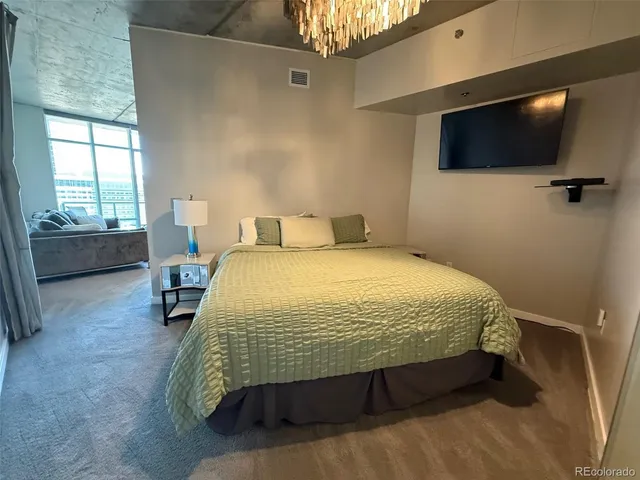 a bed sitting in a bedroom next to a window