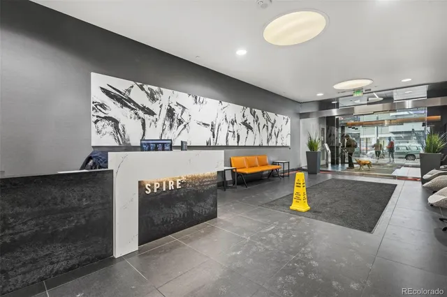 a large bedroom with a large bed and a chandelier