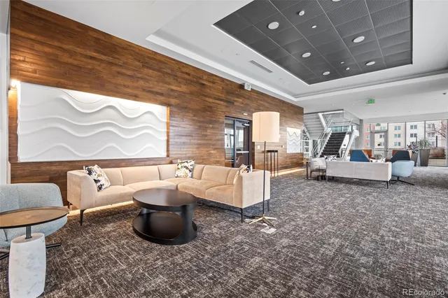 a living room with lots of furniture and a large window