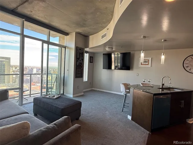 a living room with furniture and a floor to ceiling window