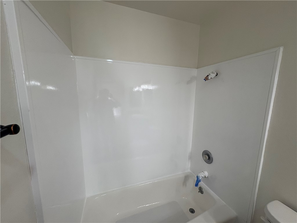 1030 West MacArthur Boulevard, Unit 116 Santa Ana, CA 92707 - Photo 12 of 15 a bathroom with a shower and a toilet