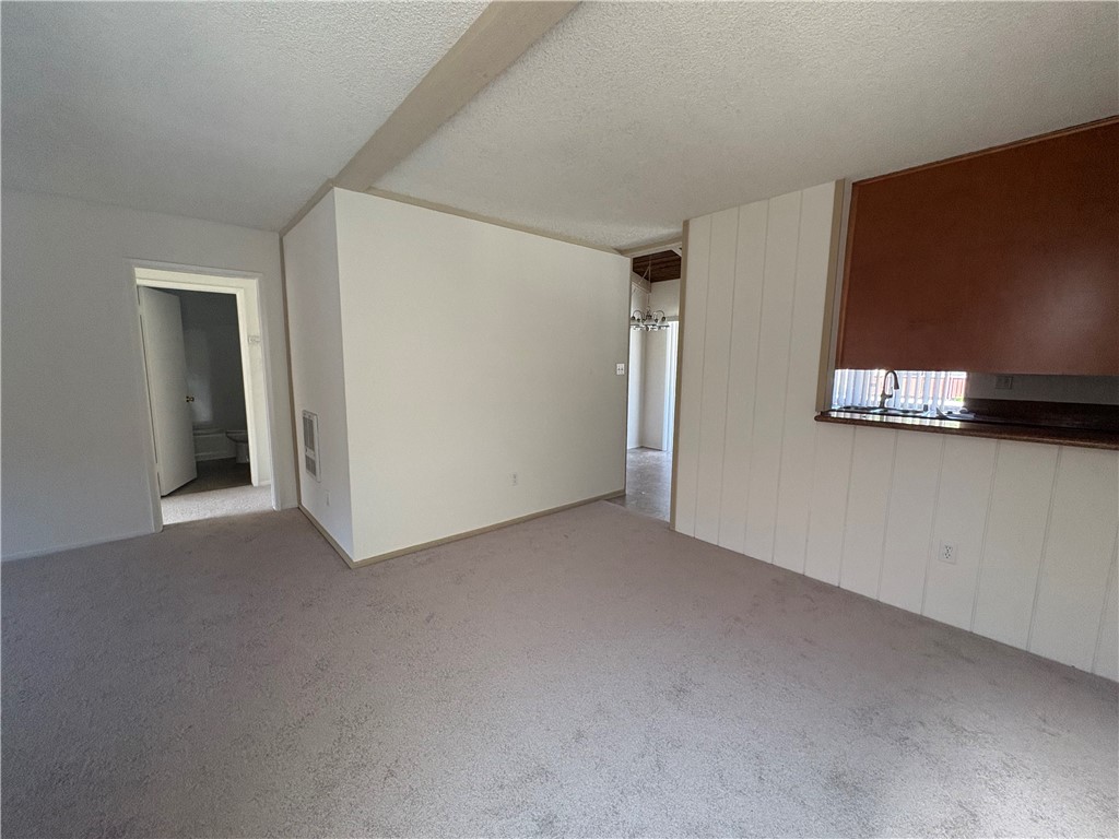 1030 West MacArthur Boulevard, Unit 116 Santa Ana, CA 92707 - Photo 5 of 15 an empty room with windows