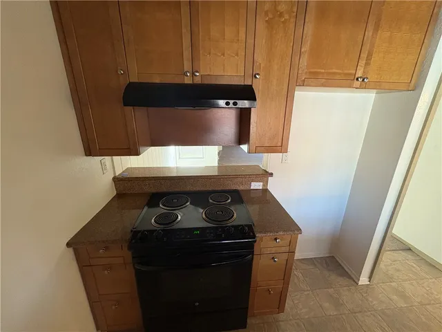 an empty room with closet and windows