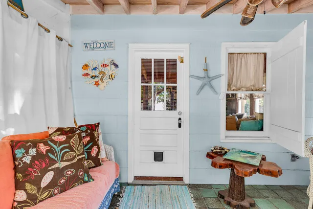 a living room with furniture and paintings on the wall