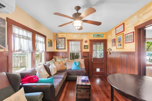 a living room with furniture and floor to ceiling windows