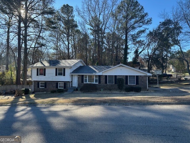 6892 Maddox Road Morrow, GA 30260 - Photo 2 of 20 a view of a large house with a big yard and large trees