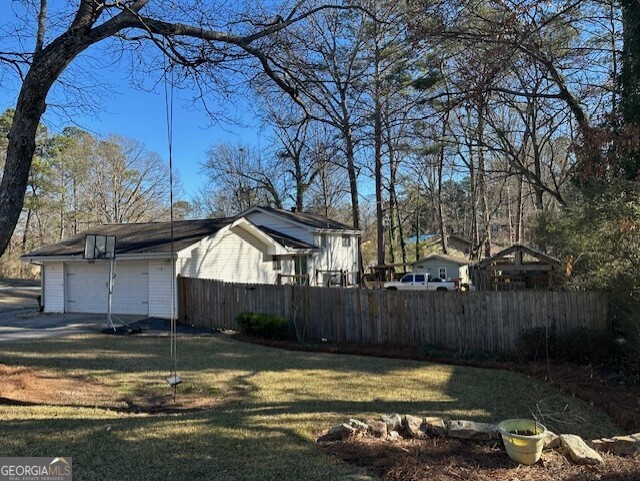6892 Maddox Road Morrow, GA 30260 - Photo 4 of 20 a view of a house with a yard fire pit and a large tree