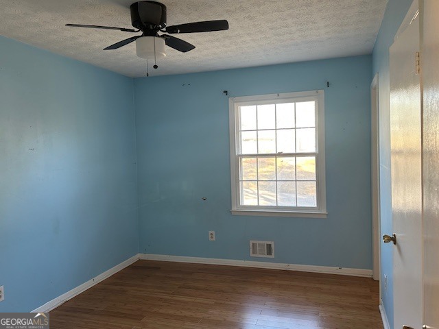 6892 Maddox Road Morrow, GA 30260 - Photo 10 of 19 a view of an empty room with wooden floor and a window