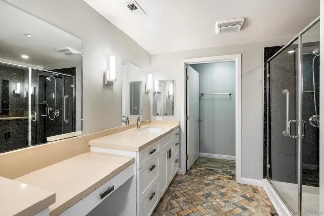 a bathroom with a tub sink and shower