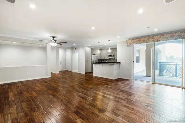 a view of a kitchen with a sink and a refrigerator