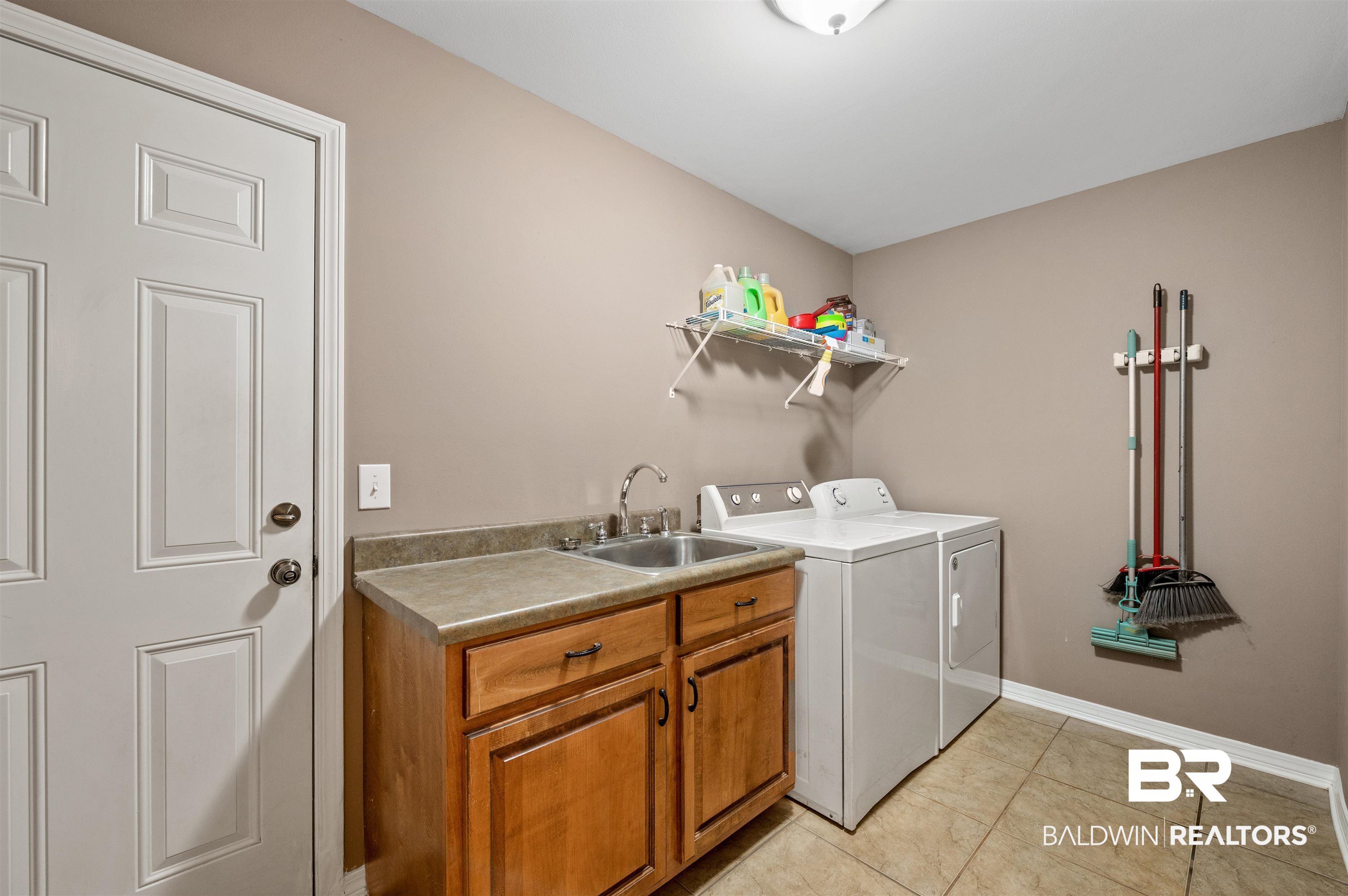 15240 Styx River Road Stapleton, AL 36578 - Photo 4 of 18 Washroom with light tile patterned flooring, washing machine and clothes dryer, cabinets, and sink