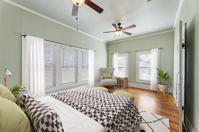 a bedroom with a large bed and a chandelier