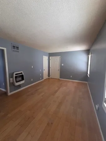a view of a livingroom with an empty space and a wooden floor